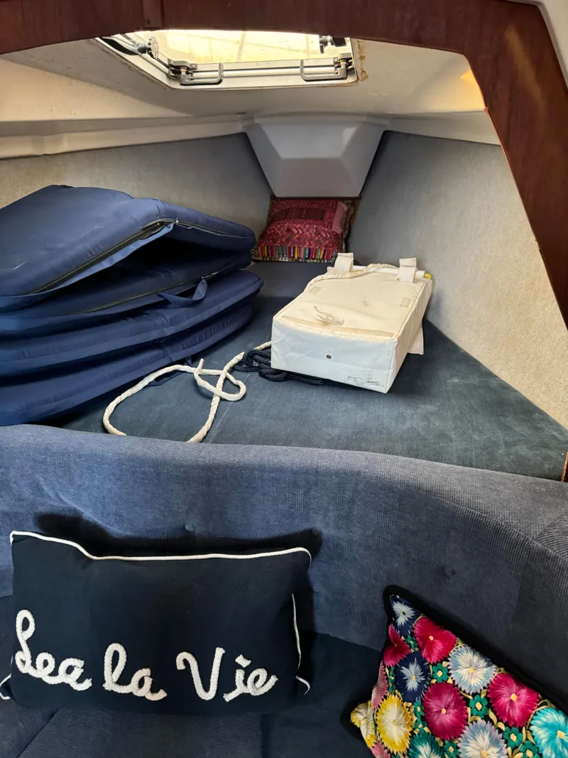 Slide: The Image of Interior of 1986 Hunter 28.5 sailboat with cushions and decorative pillows. - 9