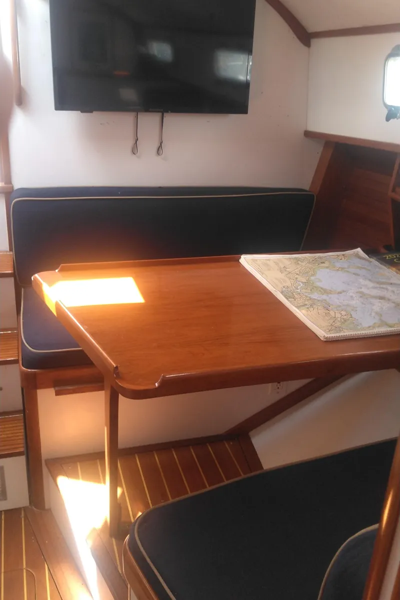 Slide: The Image of Interior of 1998 Bruckmann BLUESTAR 29 yacht with wooden table and seating area. - 11