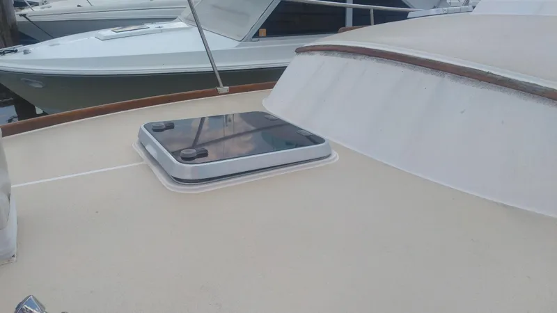 Slide: The Image of Bruckmann BLUESTAR 29 boat deck with hatch, 1998 model, docked alongside other boats. - 24