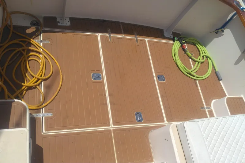 Slide: The Image of Deck of 1998 Bruckmann BLUESTAR 29 with coiled hoses and storage compartments. - 28