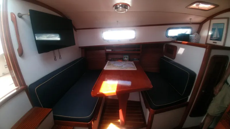 Slide: The Image of Interior of 1998 Bruckmann BLUESTAR 29 boat with dining area and map on table. - 7