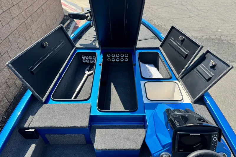 Slide: The Image of 2021 Vexus AVX1980 boat interior with open storage compartments and fishing gear. - 12