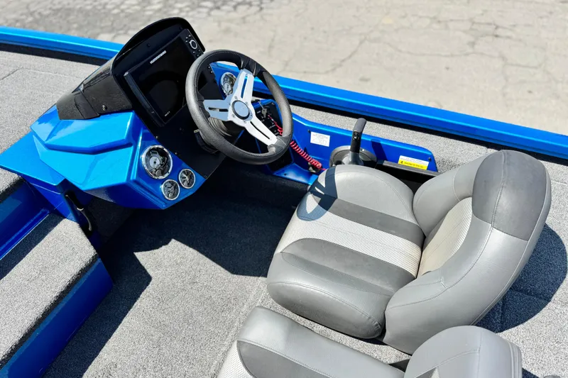 Slide: The Image of 2021 Vexus AVX1980 boat interior with blue dashboard and gray seating. - 17