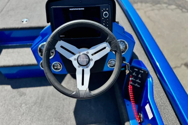 Slide: The Image of Steering wheel and dashboard of a 2021 Vexus AVX1980 boat, featuring a Humminbird display. - 18