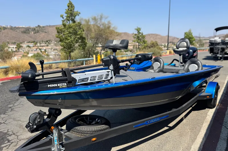 Slide: The Image of 2021 Vexus AVX1980 boat with Minn Kota Ultrex motor on trailer, parked outdoors. - 3