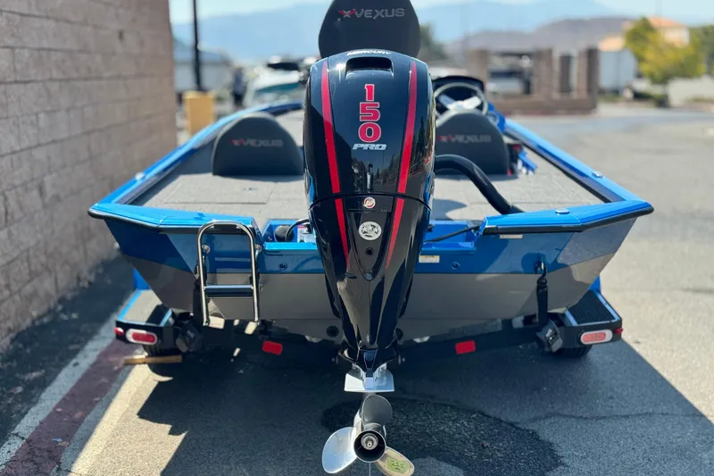 Slide: The Image of 2021 Vexus AVX1980 boat with 150 Pro engine, blue exterior, parked outdoors. - 4