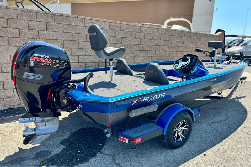 Slide: The Image of 2021 Vexus AVX1980 boat with Mercury Pro XS 150 engine, parked outdoors. - 5