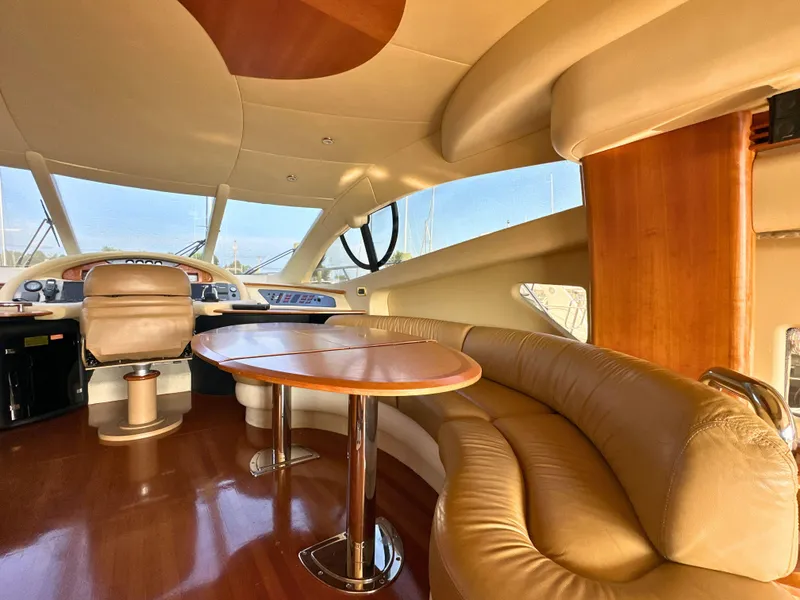 Slide: The Image of Luxurious interior of a 2010 Azimut 55E yacht with leather seating and wooden accents. - 10