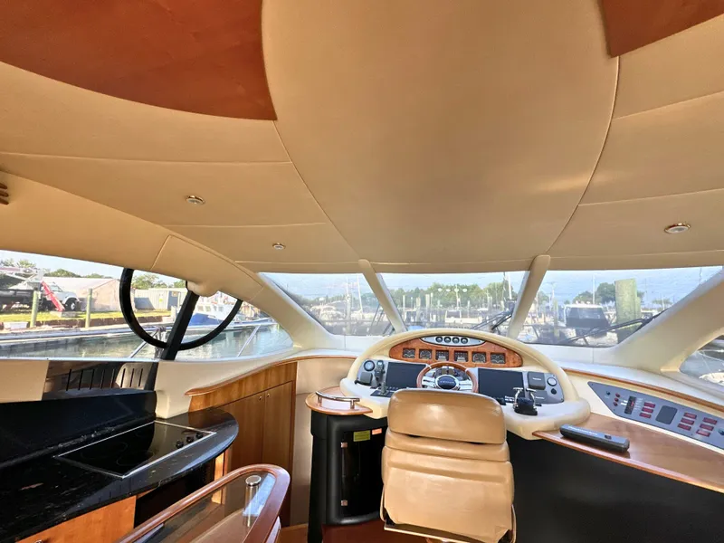Slide: The Image of Interior view of 2010 Azimut 55E yacht cockpit with modern controls and panoramic windows. - 12