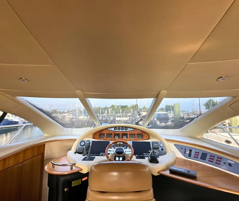 Slide: The Image of Interior view of 2010 Azimut 55E yacht cockpit with steering wheel and control panel. - 13