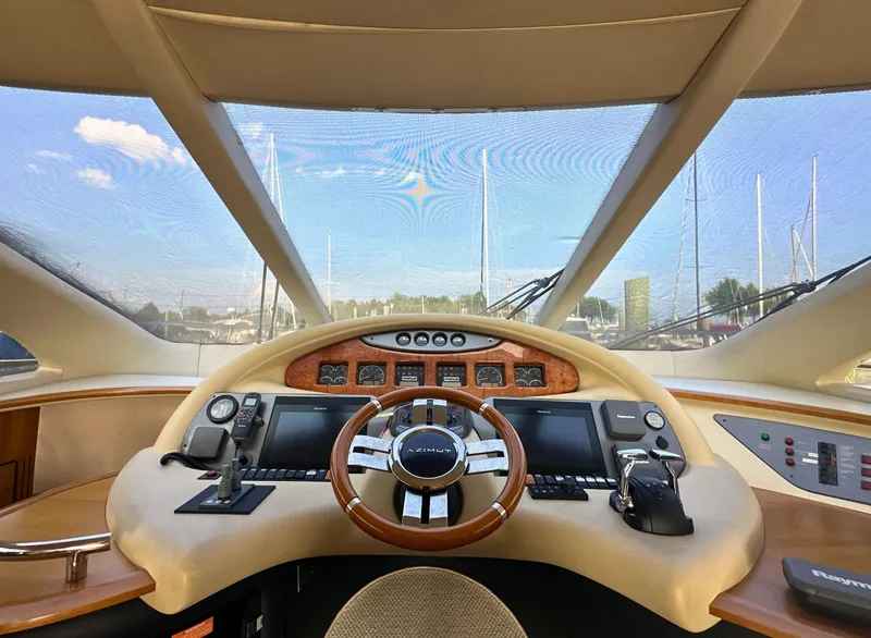 Slide: The Image of Cockpit view of a 2010 Azimut 55E yacht with modern navigation controls. - 14