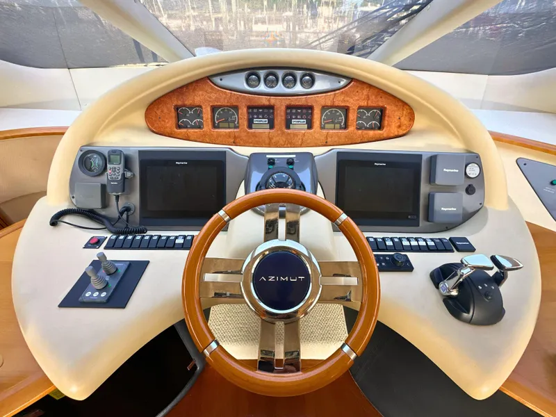 Slide: The Image of Cockpit of 2010 Azimut 55E yacht with steering wheel and navigation controls. - 15