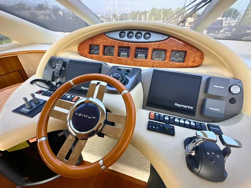 Slide: The Image of Cockpit of 2010 Azimut 55E yacht with steering wheel and navigation controls. - 16