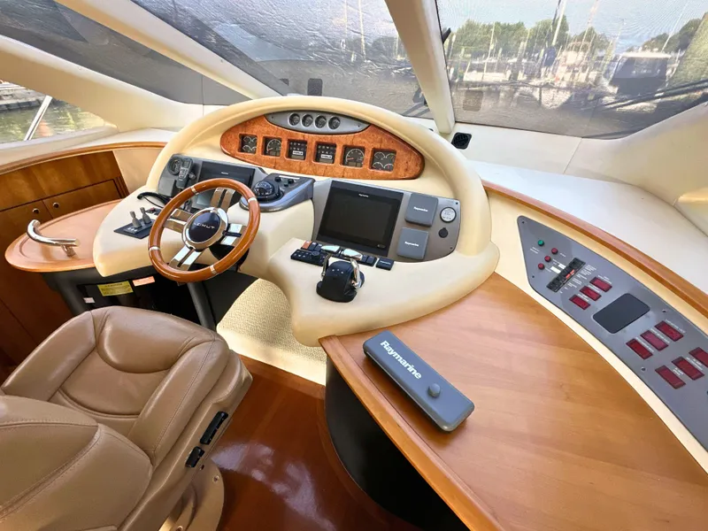 Slide: The Image of Luxurious 2010 Azimut 55E yacht helm with leather seating and advanced navigation controls. - 17