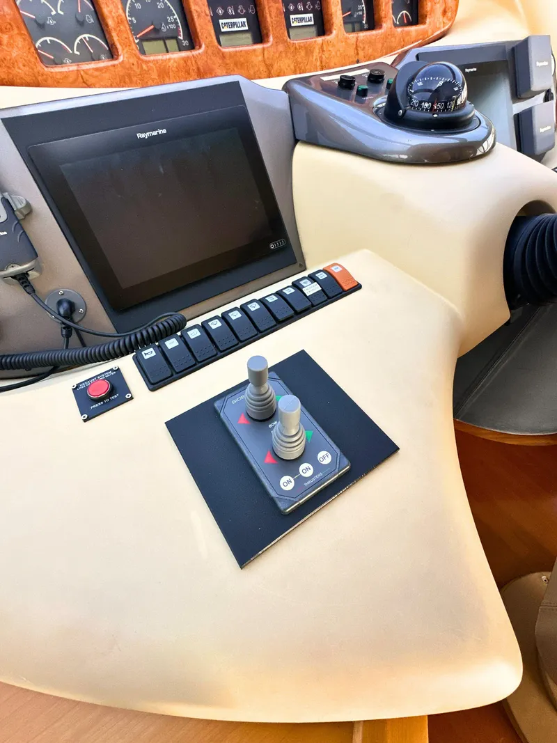 Slide: The Image of Control panel of a 2010 Azimut 55E yacht with navigation instruments and joysticks. - 19