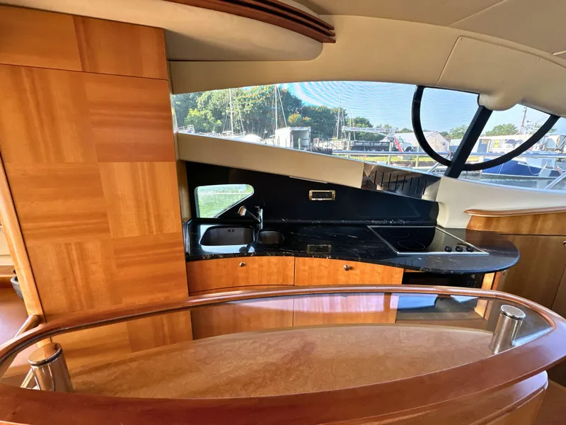 Slide: The Image of Luxurious interior of 2010 Azimut 55E yacht with modern kitchen and wooden finishes. - 21