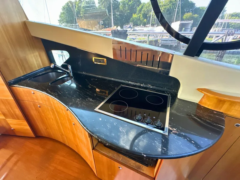 Slide: The Image of Luxurious kitchen area in a 2010 Azimut 55E yacht with sleek black countertop. - 24
