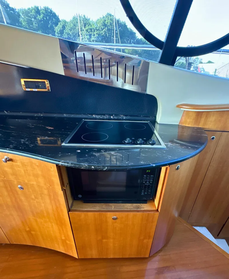 Slide: The Image of Modern kitchen area in a 2010 Azimut 55E yacht with stovetop and microwave. - 26