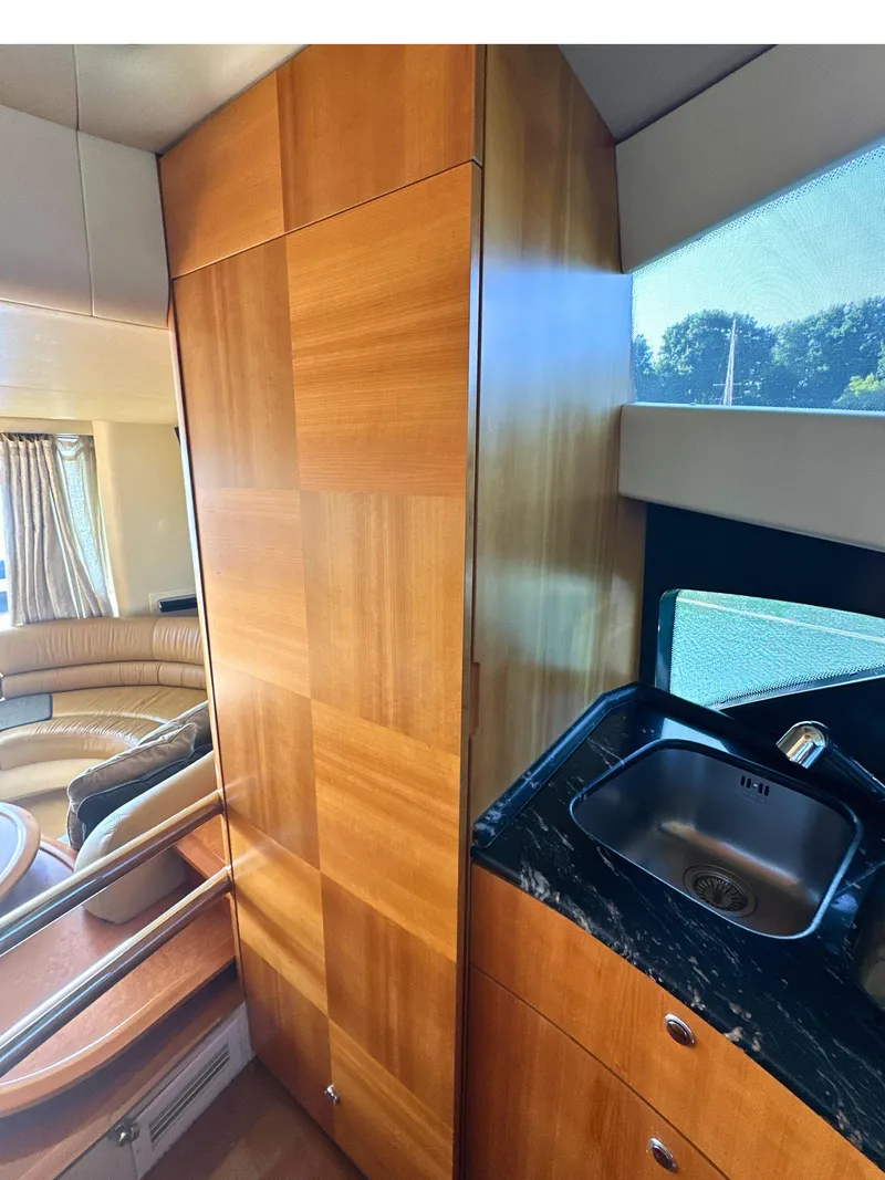 Slide: The Image of Luxurious interior of 2010 Azimut 55E yacht with wood paneling and sleek sink. - 27