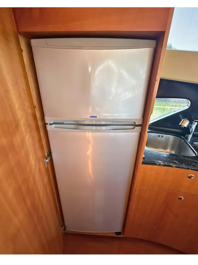 Slide: The Image of Refrigerator in 2010 Azimut 55E yacht kitchen, next to sink and wooden cabinetry. - 29