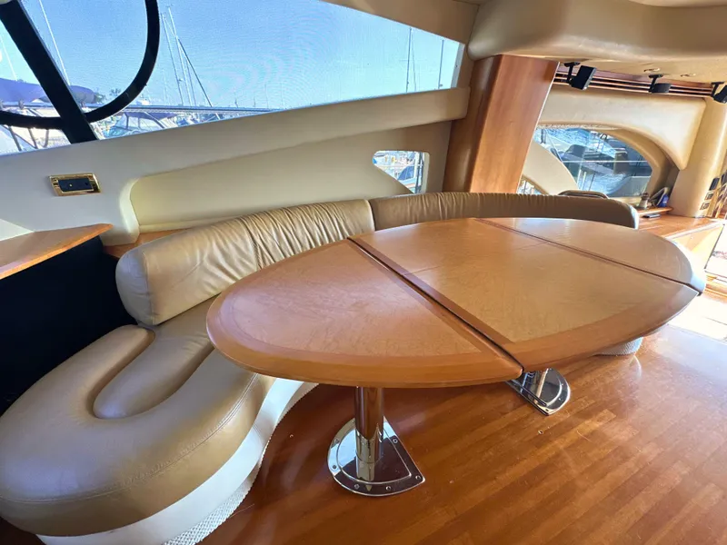 Slide: The Image of Luxurious interior of 2010 Azimut 55E yacht with elegant leather seating and wooden table. - 30
