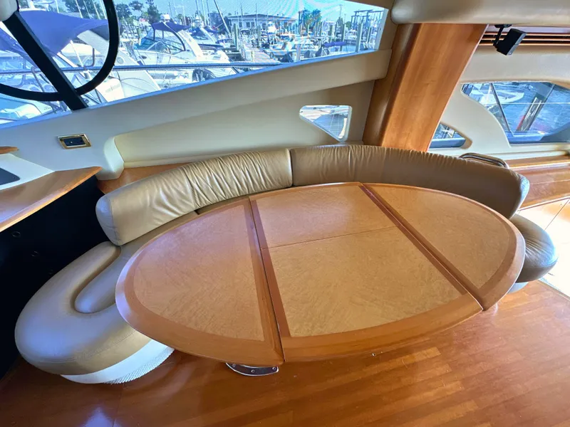 Slide: The Image of Luxurious interior of 2010 Azimut 55E yacht with elegant wooden table and leather seating. - 31