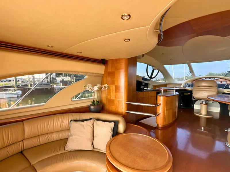 Slide: The Image of Luxurious interior of a 2010 Azimut 55E yacht with elegant wood finishes and plush seating. - 35