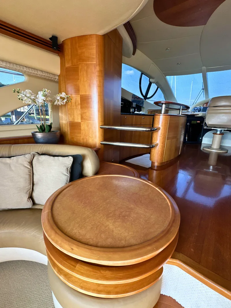 Slide: The Image of Luxurious interior of a 2010 Azimut 55E yacht with elegant wood finishes and plush seating. - 38