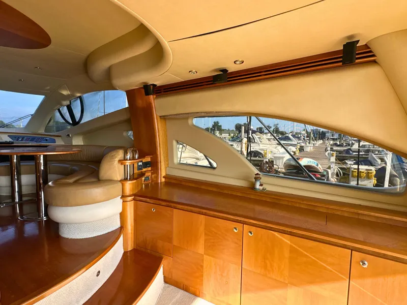 Slide: The Image of Luxurious interior of 2010 Azimut 55E yacht with elegant wood finishes and marina view. - 39