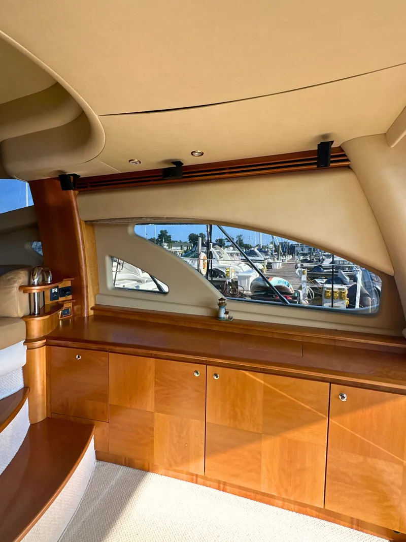 Slide: The Image of Luxurious interior of a 2010 Azimut 55E yacht with wooden cabinetry and marina view. - 40