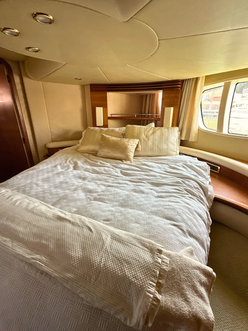 Slide: The Image of Luxurious bedroom interior of 2010 Azimut 55E yacht with elegant bedding and window view. - 42