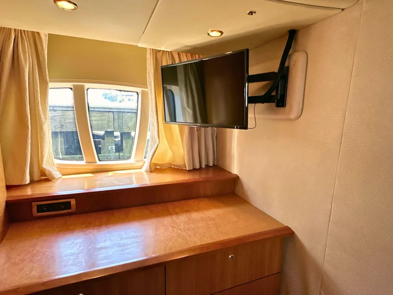 Slide: The Image of Interior of 2010 Azimut 55E yacht with TV, wooden desk, and window. - 43