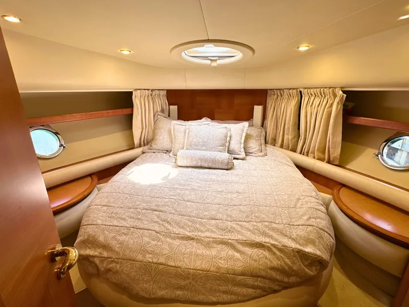 Slide: The Image of Luxurious bedroom interior of 2010 Azimut 55E yacht with elegant bedding and porthole windows. - 44