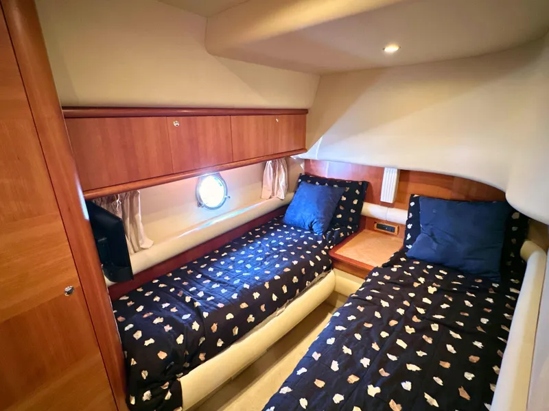 Slide: The Image of Luxurious cabin interior of 2010 Azimut 55E yacht with twin beds and wooden accents. - 45