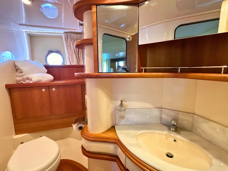 Slide: The Image of Luxurious bathroom in 2010 Azimut 55E yacht with wooden cabinetry and modern fixtures. - 46