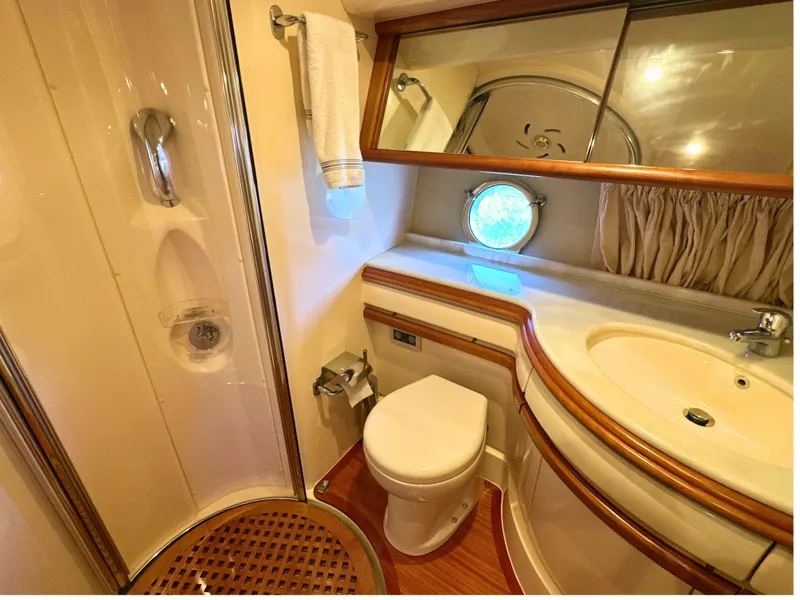 Slide: The Image of Luxurious bathroom in 2010 Azimut 55E yacht with shower, sink, and porthole window. - 49
