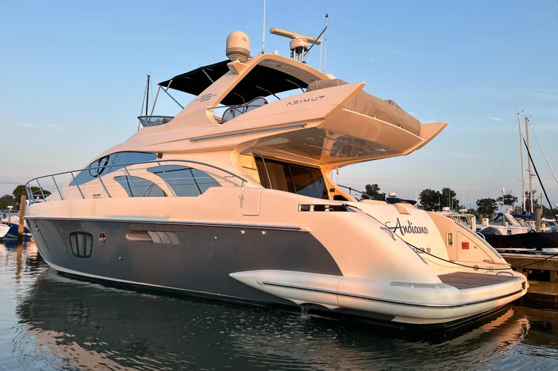 Slide: The Image of Luxurious 2010 Azimut 55E yacht docked at marina during sunset. - 5