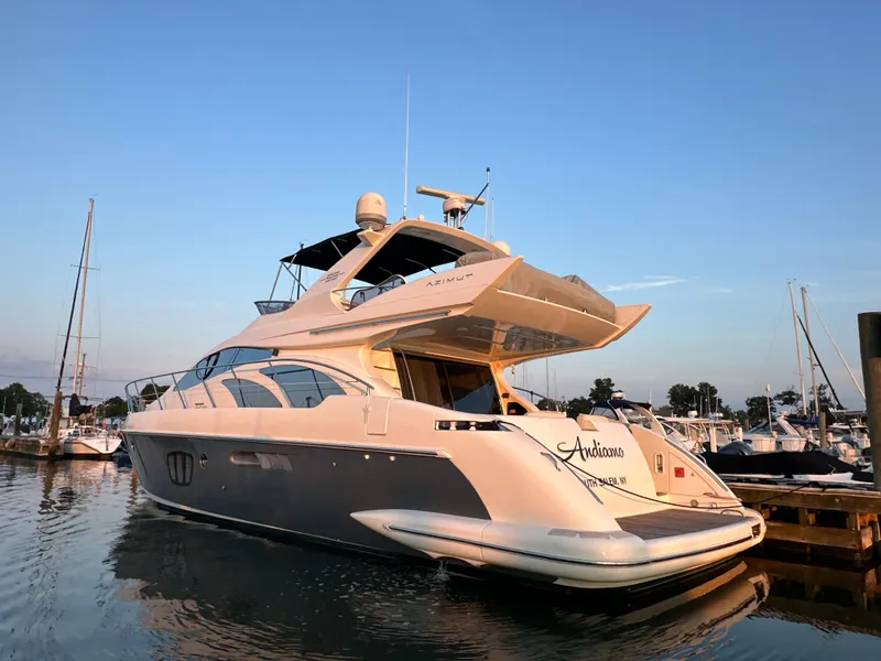 Slide: The Image of Luxury 2010 Azimut 55E yacht docked at marina during sunset. - 6