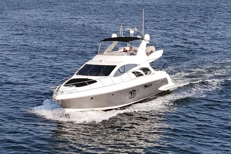Slide: The Image of Luxury 2010 Azimut 55E yacht cruising on open water. - 69