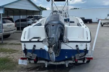 Slide: The Image of 2006 Sea Hunt 232 CC boat with outboard motor, parked in a lot. - 10