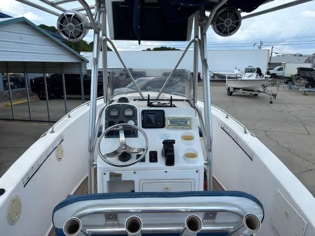 Slide: The Image of 2006 Sea Hunt 232 CC boat cockpit with steering wheel, gauges, and storage compartments. - 11