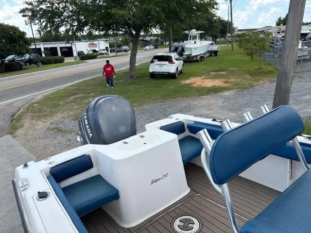 Slide: The Image of 2006 Sea Hunt 232 CC boat with Yamaha engine, parked near a road and grassy area. - 3