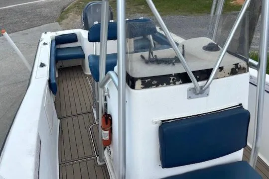 Slide: The Image of 2006 Sea Hunt 232 CC boat interior with blue seating and steering console. - 5