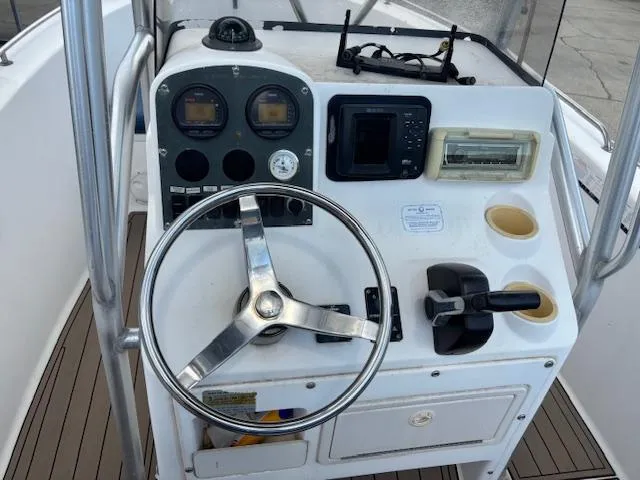 Slide: The Image of 2006 Sea Hunt 232 CC boat console with steering wheel, gauges, and controls. - 7