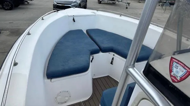 Slide: The Image of 2006 Sea Hunt 232 CC boat with blue cushioned seating in the bow area. - 8