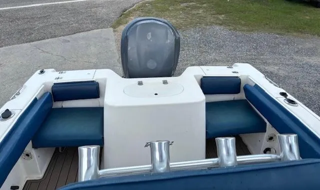 Slide: The Image of 2006 Sea Hunt 232 CC boat interior with blue seating and rod holders. - 9