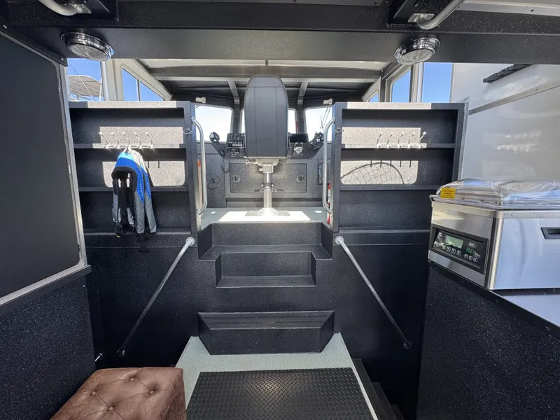 Slide: The Image of Interior of 2020 Aluminum Cruiser 42' Trawler with helm, storage, and modern equipment. - 13