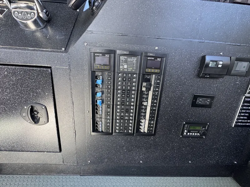 Slide: The Image of Control panel of a 2020 Aluminum Cruiser 42' Aluminum Trawler, featuring switches and gauges. - 15