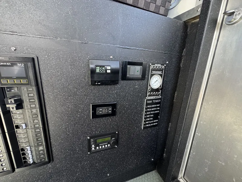 Slide: The Image of Control panel of a 2020 Aluminum Cruiser 42' Aluminum Trawler, featuring gauges and switches. - 16