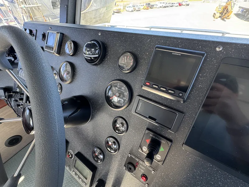 Slide: The Image of Control panel of a 2020 Aluminum Cruiser 42' Trawler with gauges and navigation equipment. - 18